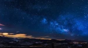 A breathtaking view of the Milky Way galaxy illuminating the night sky over mountains. jigsaw puzzle