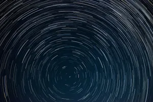 Mesmerizing view of circular star trails against a deep night sky, captured in long exposure. jigsaw puzzle