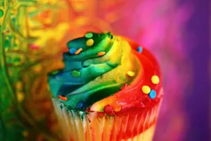 Close-up of a vibrant rainbow cupcake with colorful frosting and sprinkles. jigsaw puzzle