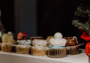 Assorted cupcakes displayed with Christmas decorations, perfect for holiday celebrations. jigsaw puzzle