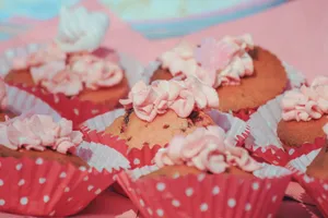 Close-up of pink frosted cupcakes in red polka dot liners, perfect for dessert lovers. jigsaw puzzle
