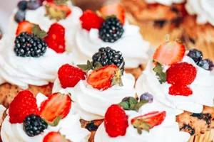 Mouth-watering cupcakes topped with fresh berries and whipped cream, perfect for a sweet treat. jigsaw puzzle