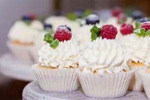 Close-up of raspberry topped cupcakes with whipped cream, perfect for dessert lovers. jigsaw puzzle