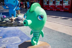 Vibrant sea-themed figurine park sculpture amidst urban backdrop. jigsaw puzzle