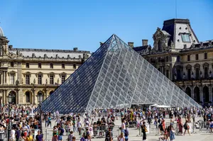 Crowded scene of the Louvre Pyramid in Paris, a famous historical landmark and tourist attraction. jigsaw puzzle