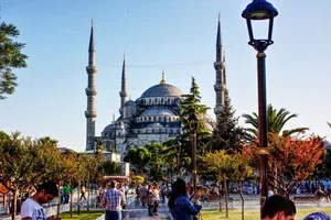 A captivating view of the Sultan Ahmed Mosque with vibrant twilight hues and visitors in Istanbul, Turkey. jigsaw puzzle