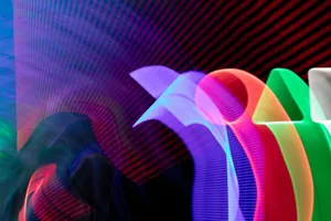 A dynamic abstract image showcasing vibrant neon light trails in various colors creating a mesmerizing visual effect. jigsaw puzzle