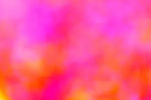 A vivid and abstract blurred background with a mix of pink, orange, and yellow hues. jigsaw puzzle