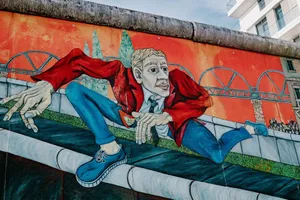 Colorful mural of a man in a red jacket on a city wall. jigsaw puzzle