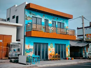 Colorful beach-themed building with murals and outdoor seating on a sunny day. jigsaw puzzle