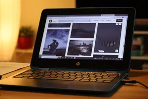 A modern HP laptop displaying images on a desk in a cozy indoor setting. jigsaw puzzle
