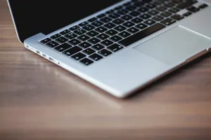 A sleek laptop on a wooden surface, showcasing elegant design and technology. jigsaw puzzle
