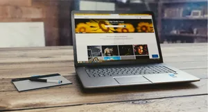 Laptop with open webpage on wooden desk, accompanied by tablet and pen, representing digital work setup. jigsaw puzzle