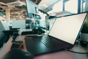 A contemporary office desk setup featuring a laptop, monitor, and headphones for a productive work environment. jigsaw puzzle