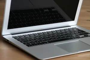 Close-up of a modern, sleek laptop resting on a wooden desk, emphasizing its portability and design. jigsaw puzzle