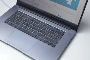 From above of modern portable computer with open analytical program on screen on white table jigsaw puzzle