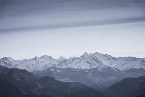 A stunning view of a snowcapped mountain range under clear skies, showcasing natural beauty. jigsaw puzzle