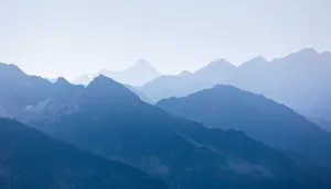 A tranquil view of the blue mountain peaks at dusk, capturing nature's beauty. jigsaw puzzle