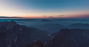 Stunning aerial view of misty mountains at twilight, capturing serene nature. jigsaw puzzle