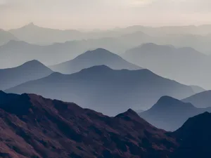 Enchanting view of misty mountain layers creating a mysterious twilight atmosphere. jigsaw puzzle