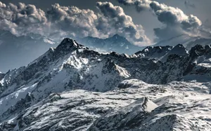 Majestic snow-covered mountains under dramatic clouds in Lombardy, Italy. jigsaw puzzle