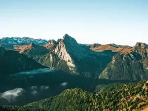 A breathtaking view of a mountain range under clear skies, showcasing nature's beauty. jigsaw puzzle