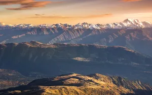 Breathtaking sunset view of snow-capped mountains with clear skies and vibrant colors. jigsaw puzzle