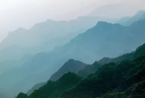 Serene misty mountain range in Taiwan at dawn, with layered silhouettes and morning fog. jigsaw puzzle