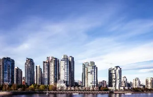 Panoramic view of Vancouver's skyline with skyscrapers and waterfront under a clear blue sky. jigsaw puzzle