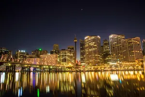 Stunning night view of Sydney's skyline with building reflections over the calm water enhancing urban beauty. jigsaw puzzle