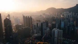 Captivating sunset view of Kowloon skyscrapers with mountains in the backdrop. Perfect for urban exploration themes. jigsaw puzzle