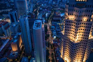 Stunning aerial view of Singapore's skyline at night, showcasing illuminated skyscrapers and city lights. jigsaw puzzle