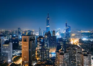Stunning aerial view of Nanjing skyscrapers illuminated at night with vibrant city lights and a clear sky. jigsaw puzzle