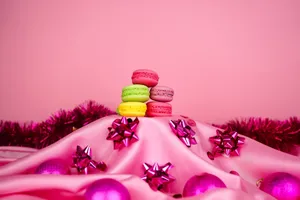 Colorful macarons on pink silk with festive decorations. Perfect for holidays. jigsaw puzzle