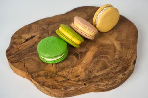 A vibrant assortment of French macarons on a rustic wooden platter, showcasing their colorful and delicate texture. jigsaw puzzle