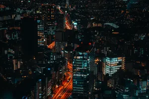 A vibrant aerial view of Shibuya's cityscape with glowing skyscrapers and bustling streets at night. jigsaw puzzle