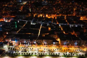 A stunning aerial view showcasing vibrant city streets illuminated at night with vivid lights. jigsaw puzzle