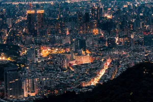 A captivating aerial view of a glowing cityscape at night with illuminated skyscrapers and bustling streets. jigsaw puzzle