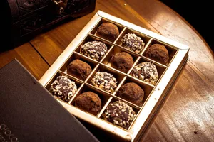 A gourmet selection of chocolate truffles in an elegant box, perfect for indulgence. jigsaw puzzle