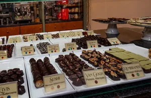 A tempting array of gourmet chocolates on display in a café. Perfect for dessert lovers. jigsaw puzzle